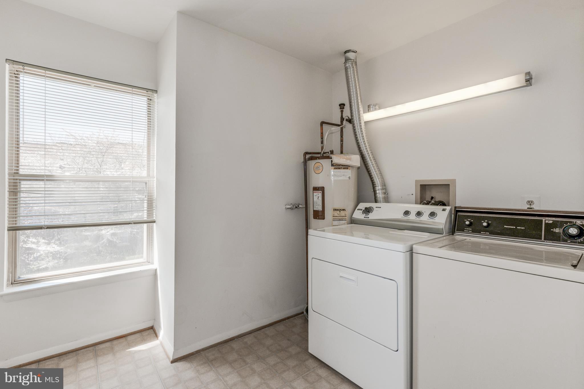 7804 Guildberry Court, Unit 303 Gaithersburg, MD 20879 - Photo 17 of 21 a utility room with dryer and washer