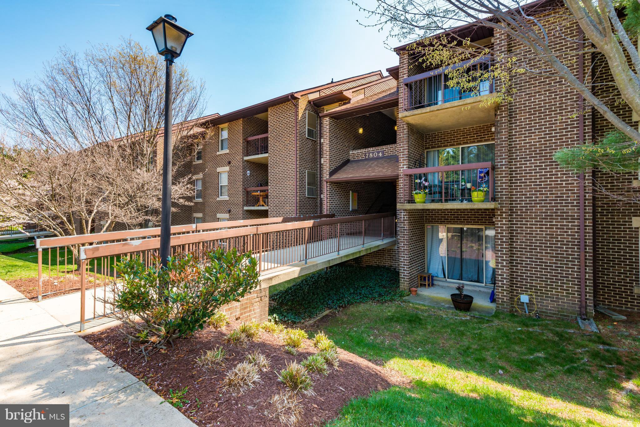7804 Guildberry Court, Unit 303 Gaithersburg, MD 20879 - Photo 21 of 21 a front view of a house with garden