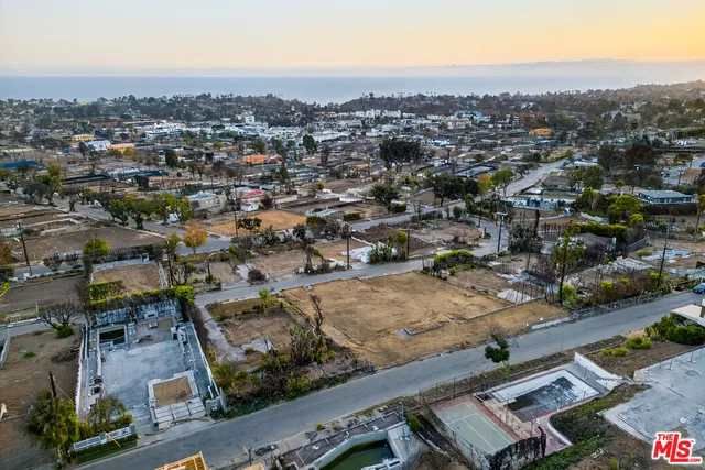 an aerial view of residential houses with city view
