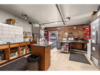 a open kitchen with stainless steel appliances kitchen island granite countertop a refrigerator a stove and a sink with dishwasher