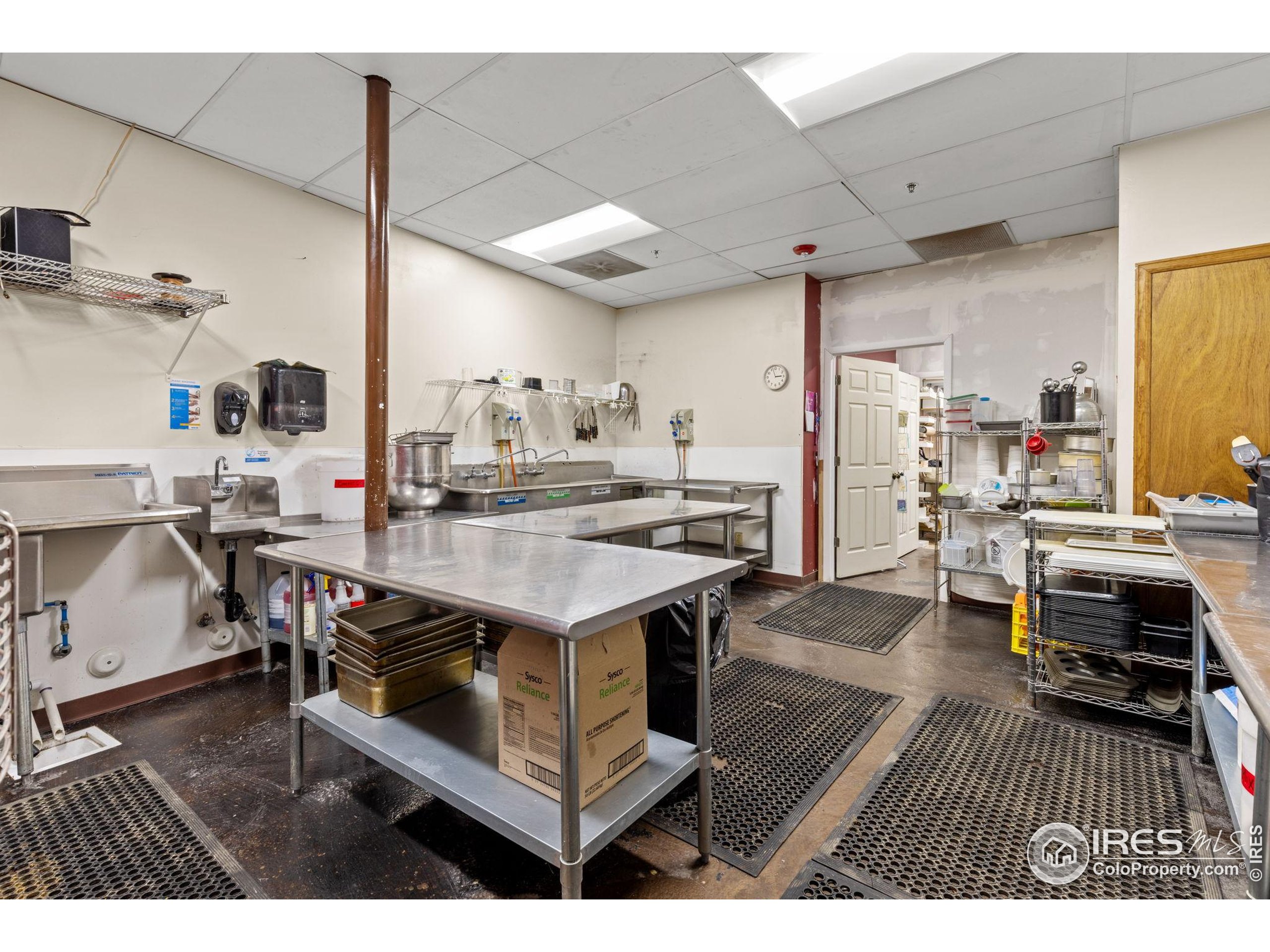 331 Main Street Longmont, CO 80501 - Photo 19 of 50 a living room with a table chairs and a kitchen view