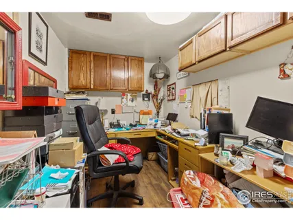 a view of a workspace with furniture and a window