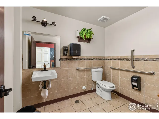 a bathroom with a toilet a sink and mirror