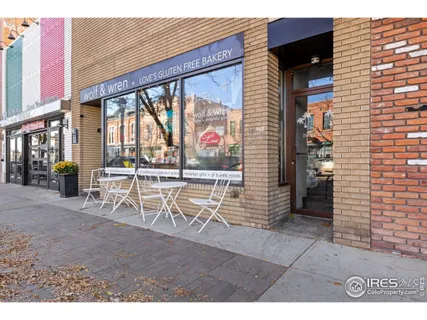 a dining room with furniture and a floor to ceiling window