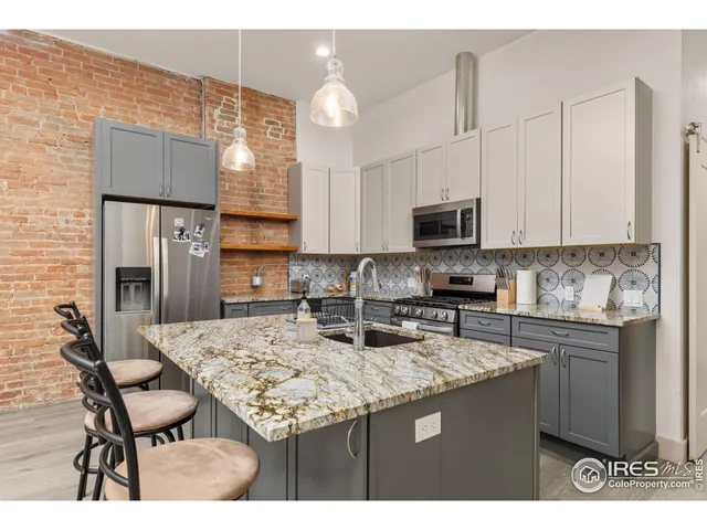 a kitchen with a sink and a stove