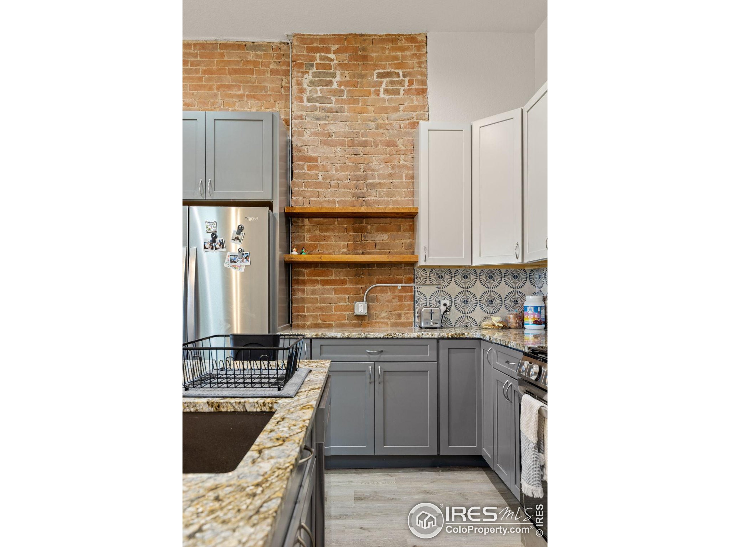 331 Main Street Longmont, CO 80501 - Photo 32 of 50 a kitchen with a sink and a stove