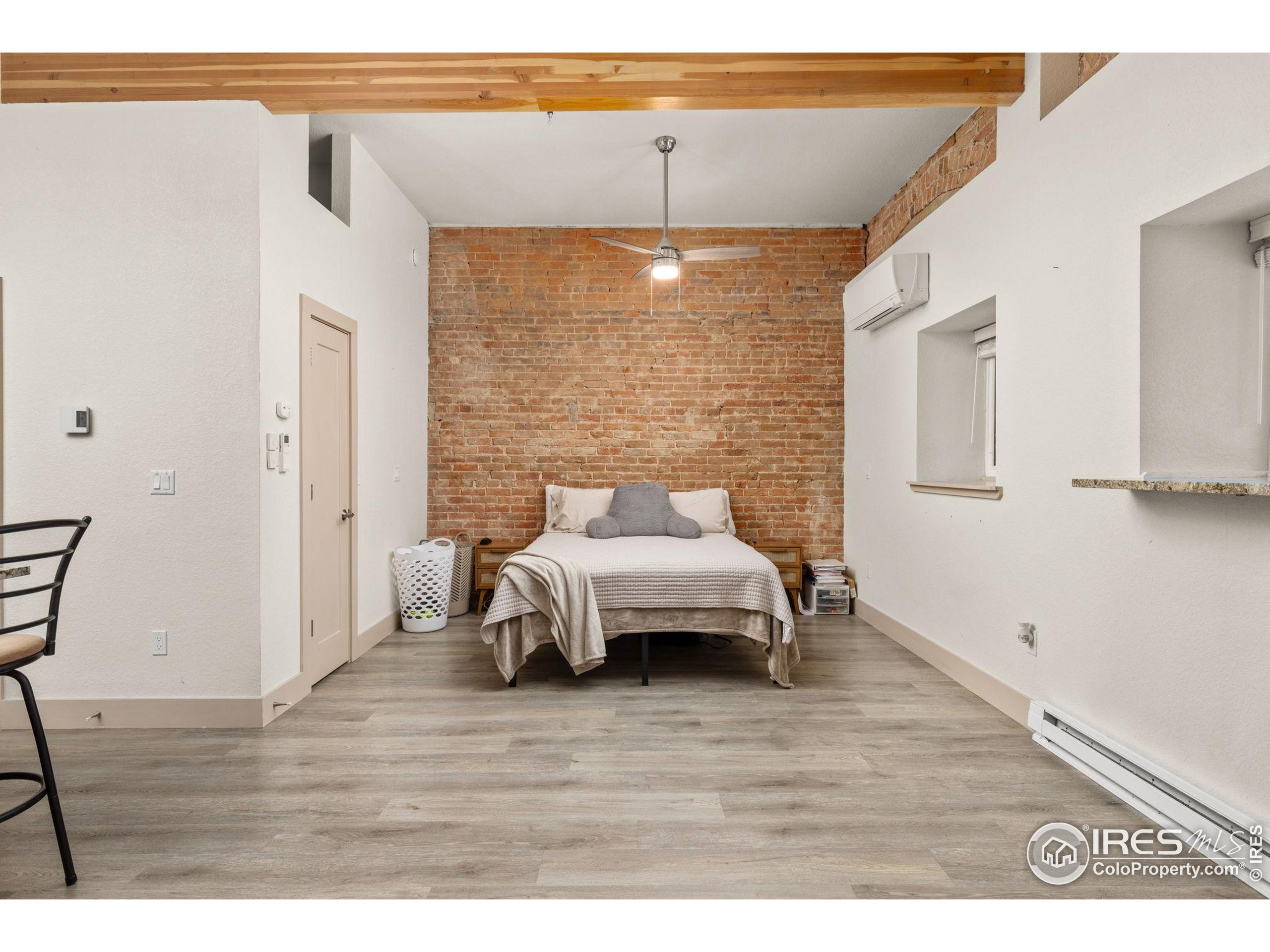 331 Main Street Longmont, CO 80501 - Photo 33 of 50 a bedroom with a bed and wooden floor