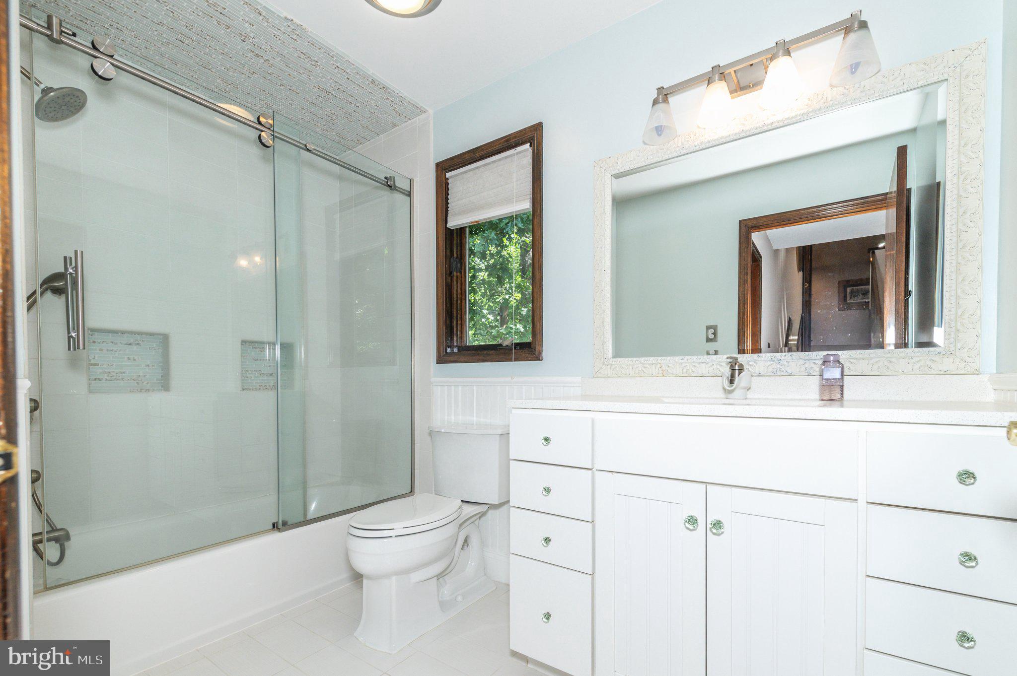 434 4th Street Atco, NJ 08004 - Photo 26 of 69 a bathroom with a toilet a sink a mirror a shower a vanity and window