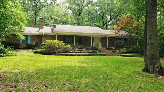a front view of house with yard and outdoor seating