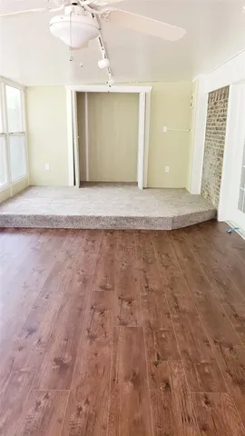 a view of a big room with wooden floor and a outdoor space