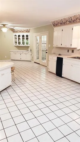 a view of a yard with plants and a bench
