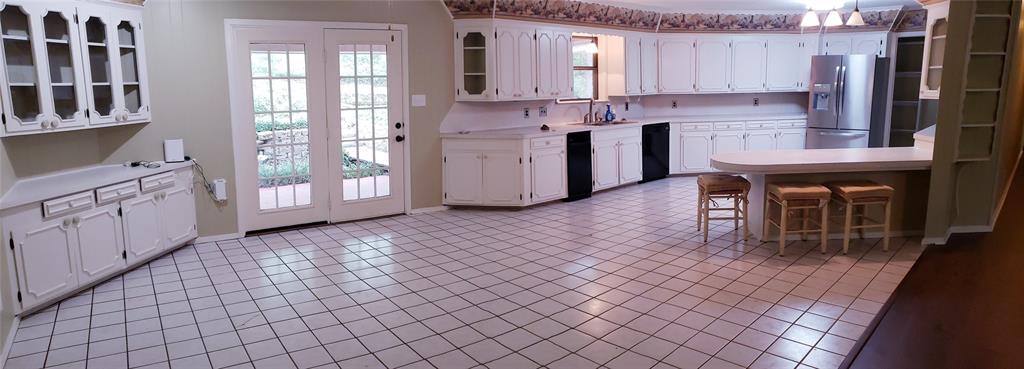 401 South Timberlane Lone Star, TX 75668 - Photo 2 of 27 a kitchen with stainless steel appliances granite countertop a stove a sink and a refrigerator