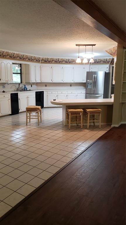 401 South Timberlane Lone Star, TX 75668 - Photo 3 of 27 a large kitchen with stainless steel appliances a stove and white cabinets