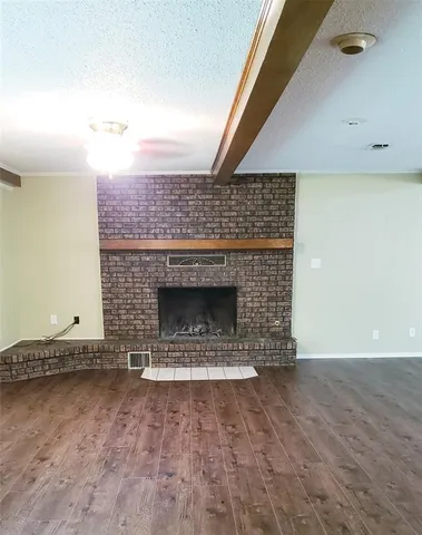 a view of empty room with a fireplace