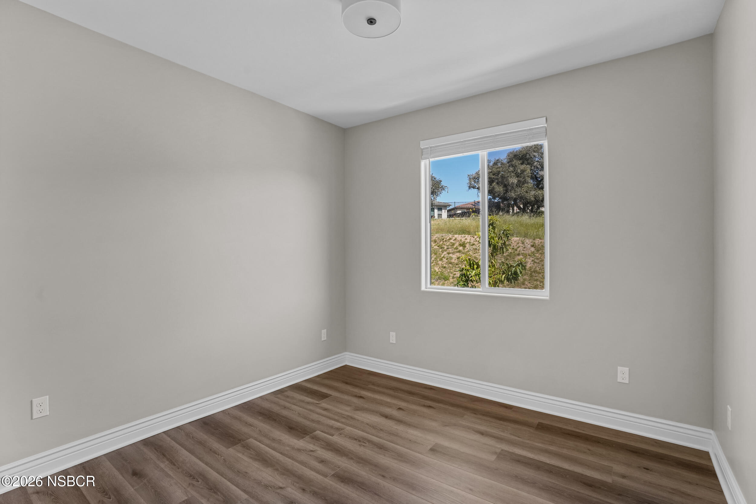1147 Ginger Place Santa Maria, CA 93455 - Photo 20 of 55 a view of an empty room with wooden floor and a window