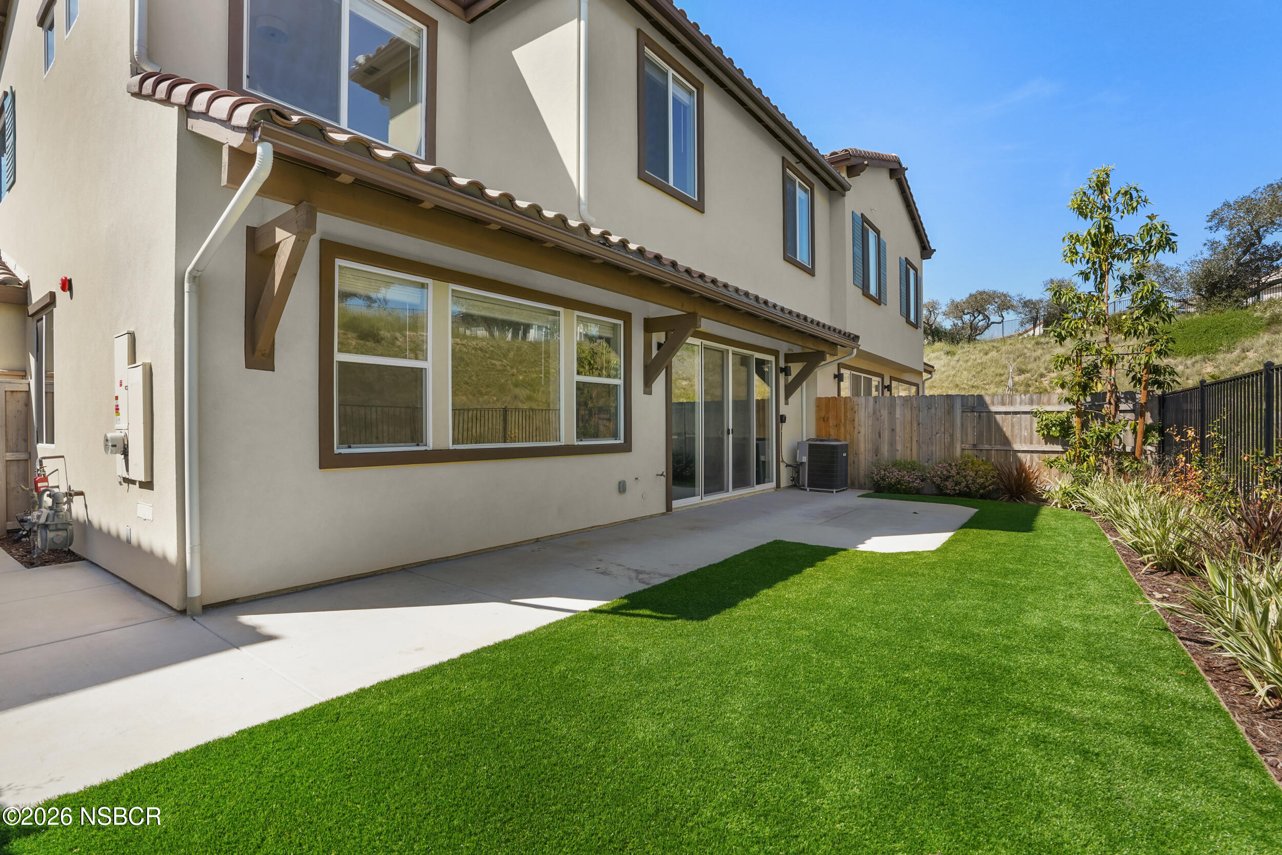 1147 Ginger Place Santa Maria, CA 93455 - Photo 29 of 55 a view of a house with brick walls and a yard with a large tree