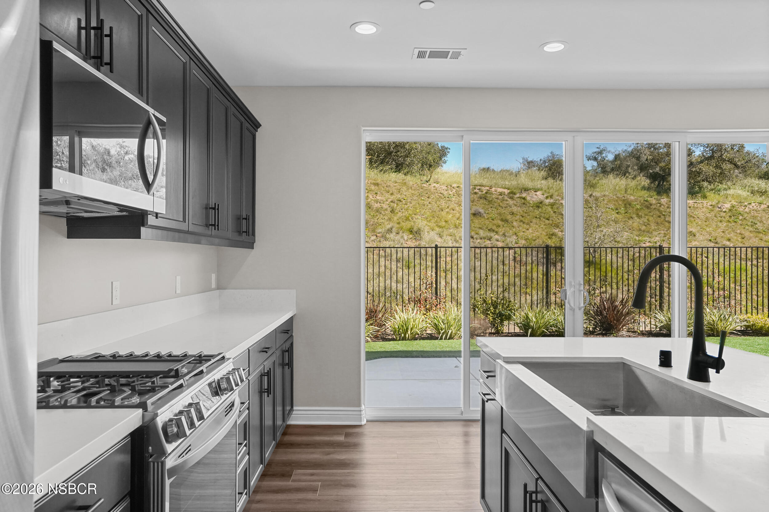 1147 Ginger Place Santa Maria, CA 93455 - Photo 7 of 55 a kitchen with a sink a counter top space and stainless steel appliances