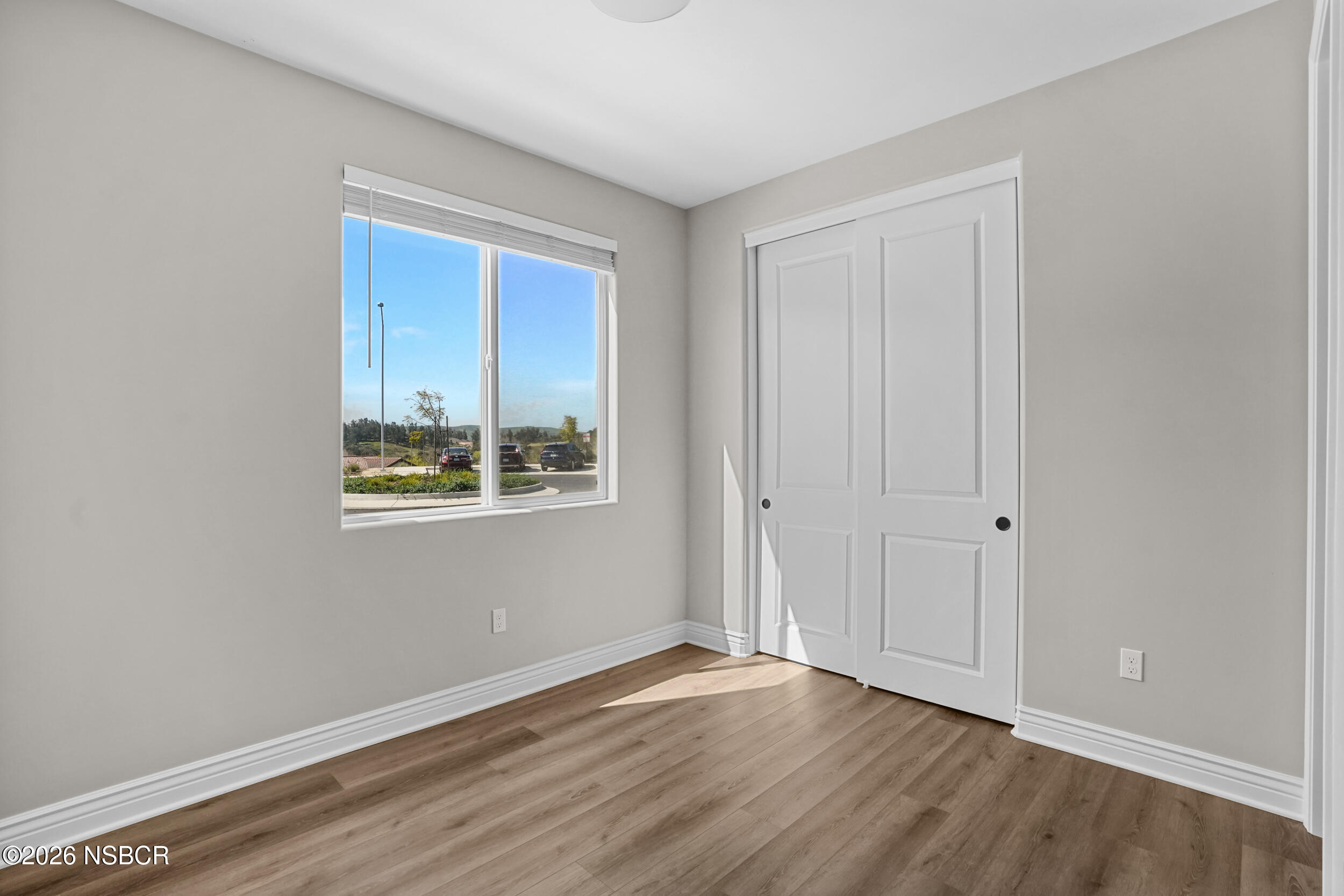 1147 Ginger Place Santa Maria, CA 93455 - Photo 10 of 55 a view of an empty room with wooden floor and a window