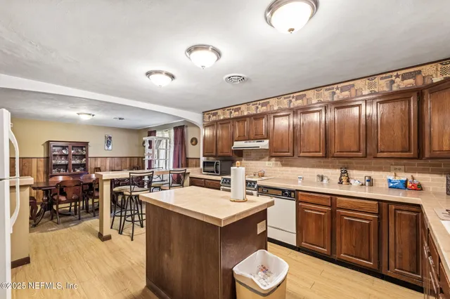 a backyard of a house with table and chairs