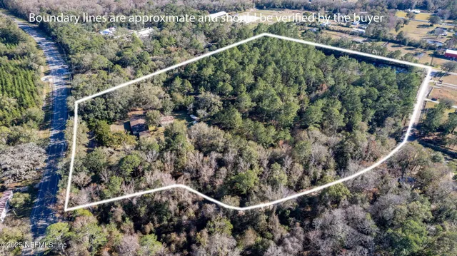 a kitchen with stainless steel appliances kitchen island granite countertop a refrigerator a stove a sink a dining table and chairs with wooden floor