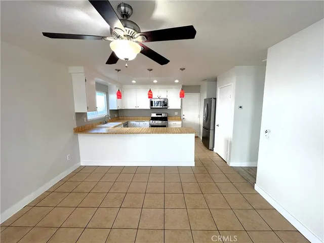 a kitchen with stainless steel appliances granite countertop a stove a refrigerator a sink and a microwave