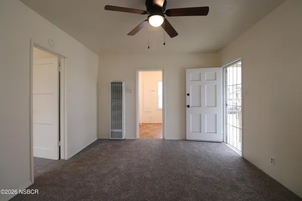 a view of empty room with ceiling fan