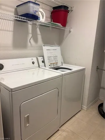a living room with couch and a floor to ceiling window