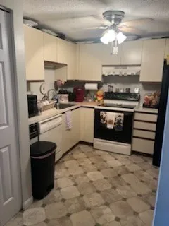 a kitchen with a stove cabinets and a sink