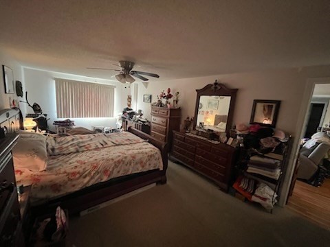 8 9th Street, Unit 513 Medford, MA 02155 - Photo 5 of 10 a bed room with a bed and a mirror