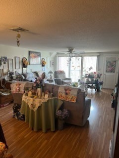 8 9th Street, Unit 513 Medford, MA 02155 - Photo 6 of 10 a living room with lots of furniture and a wooden floor