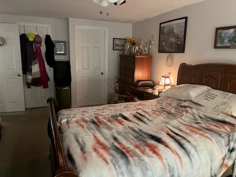 a bedroom with a bed and a television