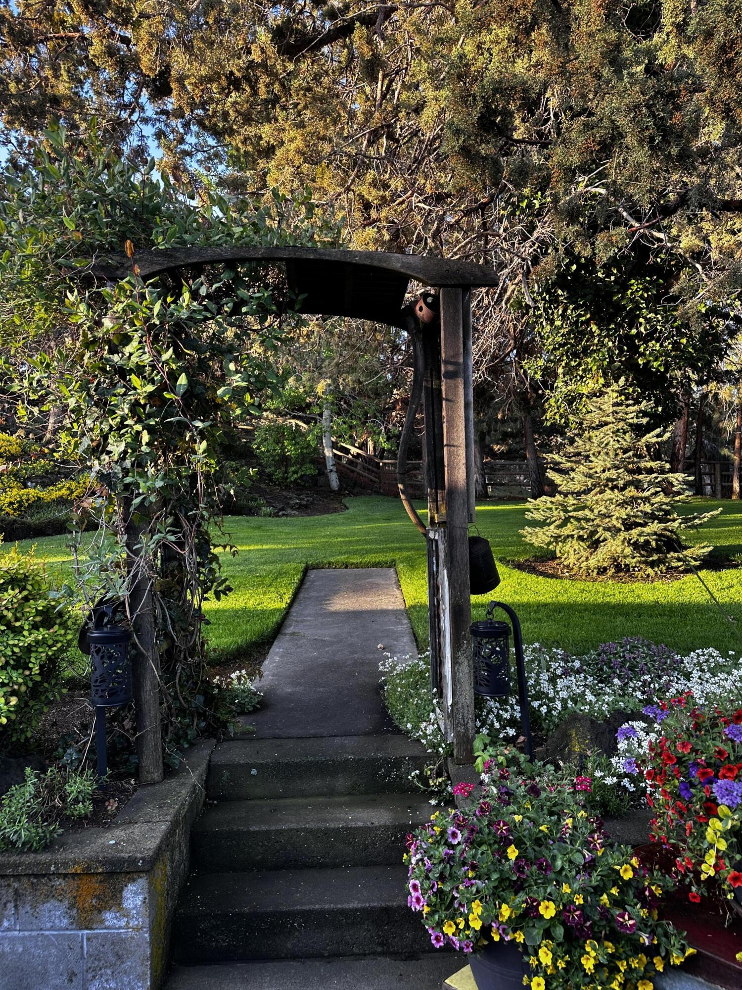 22539 Martee Lane Bend, OR 97701 - Photo 37 of 54 a view of a garden with plants and large trees