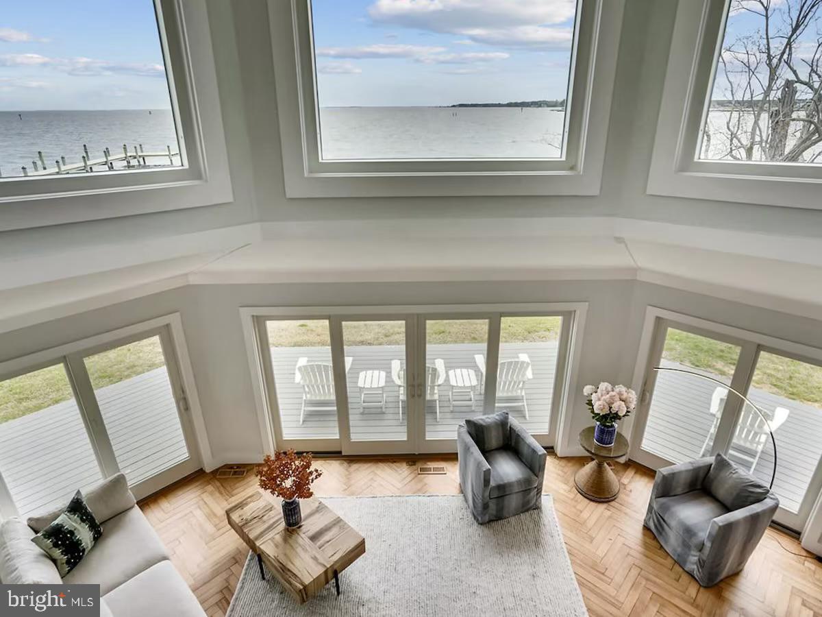 21642 Chicken Point Road Tilghman, MD 21671 - Photo 5 of 63 a living room with furniture and floor to ceiling windows