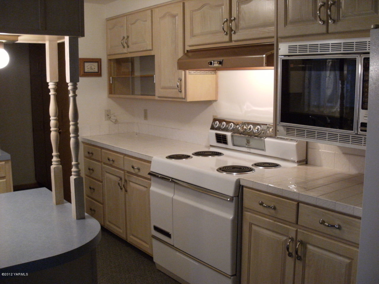 1212 Swan Road Sunnyside, WA 98944 - Photo 2 of 8 a kitchen with cabinets and stainless steel appliances