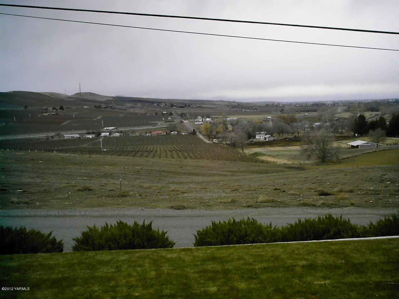 1212 Swan Road Sunnyside, WA 98944 - Photo 8 of 8 a view of a lake with houses in the background