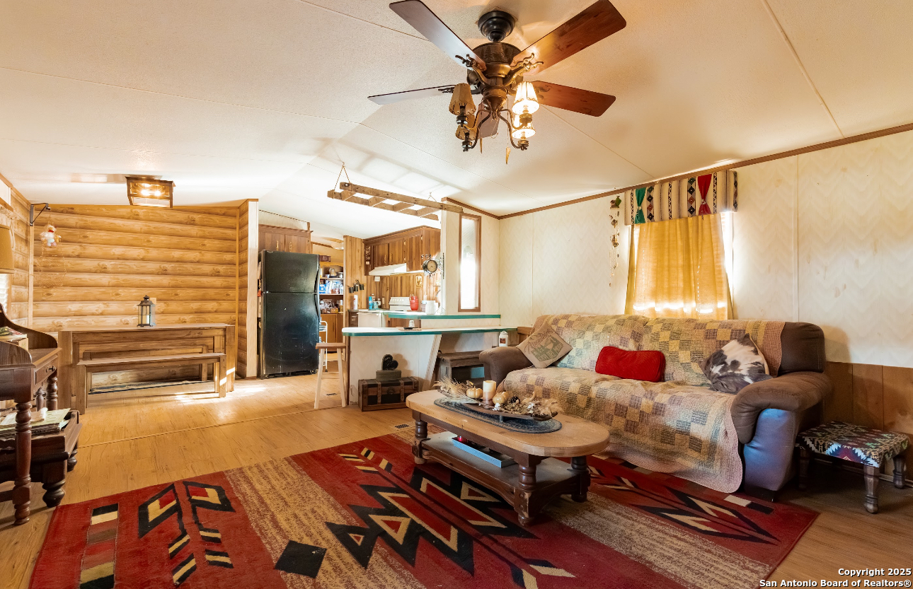 1440 Rendon Road Poteet, TX 78065 - Photo 16 of 22 a living room with furniture and a chandelier