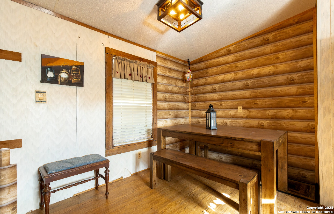 1440 Rendon Road Poteet, TX 78065 - Photo 17 of 22 a bedroom with a bed and a chandelier