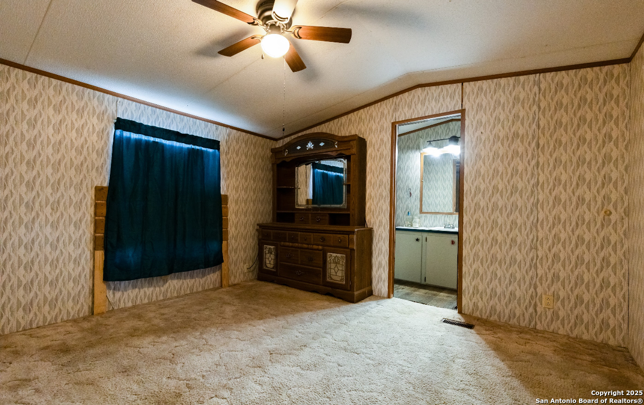 1440 Rendon Road Poteet, TX 78065 - Photo 18 of 22 an empty room with closet and windows