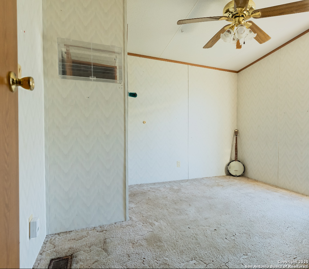 1440 Rendon Road Poteet, TX 78065 - Photo 20 of 22 a view of a garage with sliding door and wooden door