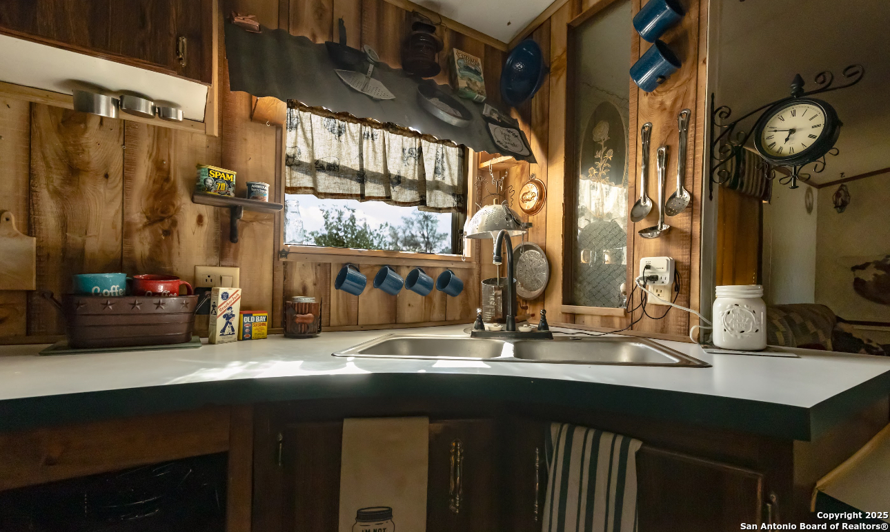 1440 Rendon Road Poteet, TX 78065 - Photo 22 of 22 a bathroom with a sink and a mirror