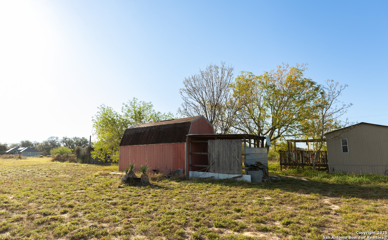 1440 Rendon Road Poteet, TX 78065 - Photo 8 of 22 a backyard of a house with lots of green space