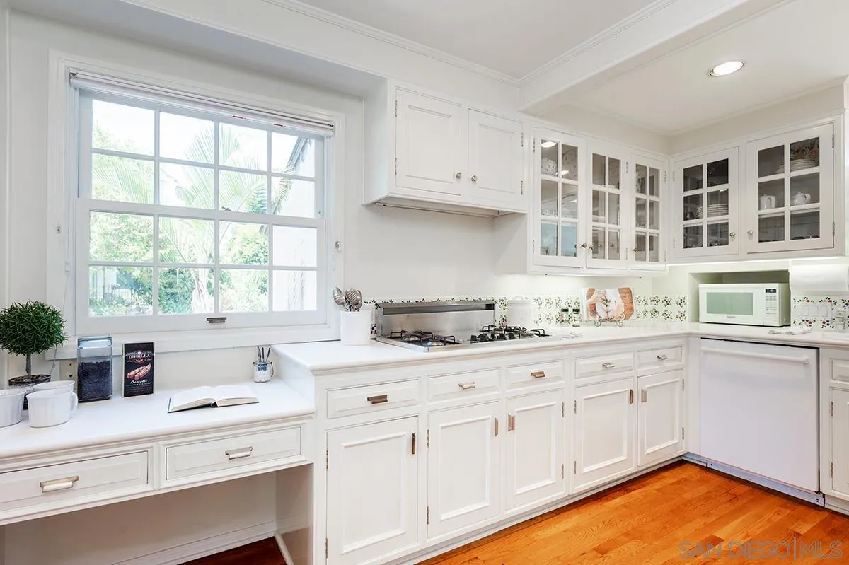 305 West Olive Street San Diego, CA 92103 - Photo 23 of 74 a kitchen with granite countertop white cabinets and white appliances