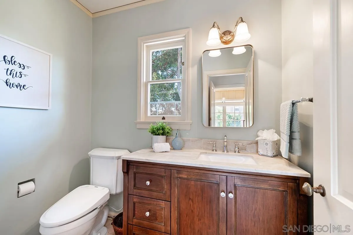 305 West Olive Street San Diego, CA 92103 - Photo 31 of 74 a bathroom with a toilet a sink and mirror