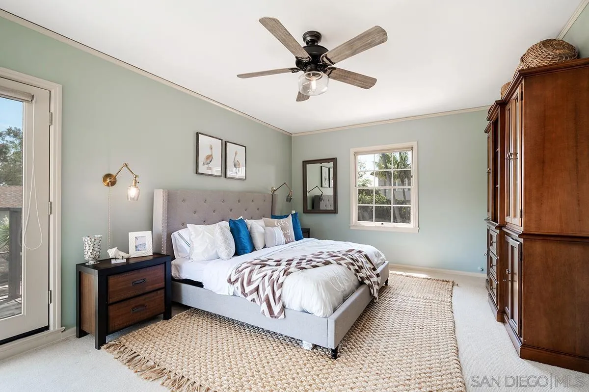 305 West Olive Street San Diego, CA 92103 - Photo 35 of 74 a bedroom with a bed a window and a chandelier