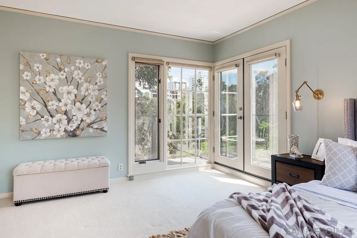 305 West Olive Street San Diego, CA 92103 - Photo 36 of 74 a bedroom with a large bed and a couch next to a window