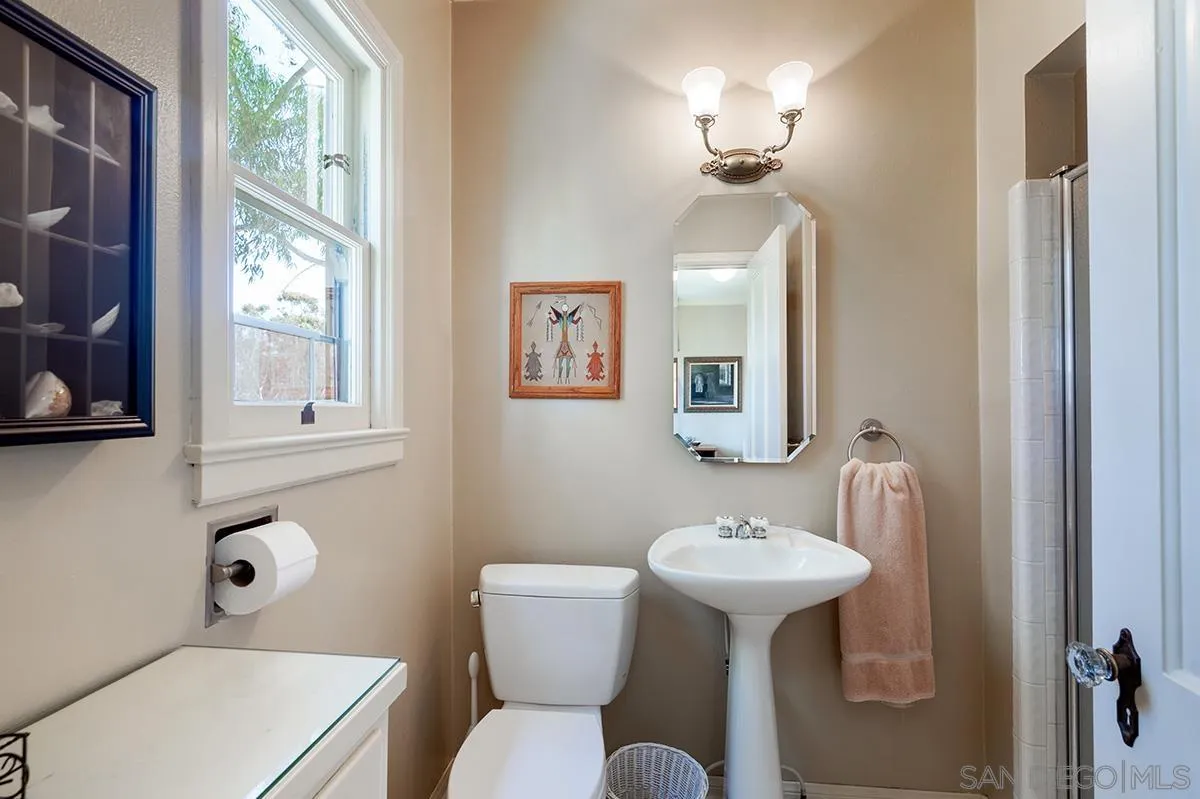305 West Olive Street San Diego, CA 92103 - Photo 38 of 74 a bathroom with a toilet sink and mirror