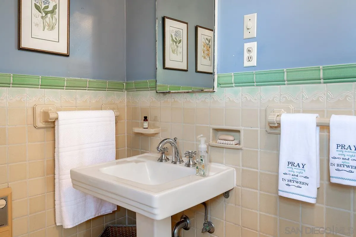 305 West Olive Street San Diego, CA 92103 - Photo 53 of 74 a bathroom with a sink a toilet and a mirror