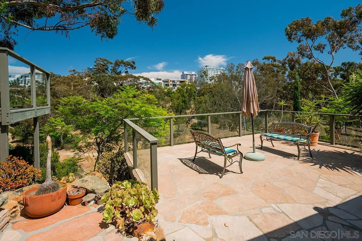 305 West Olive Street San Diego, CA 92103 - Photo 67 of 74 a view of a swimming pool with a lounge chair and tables back yard of the house