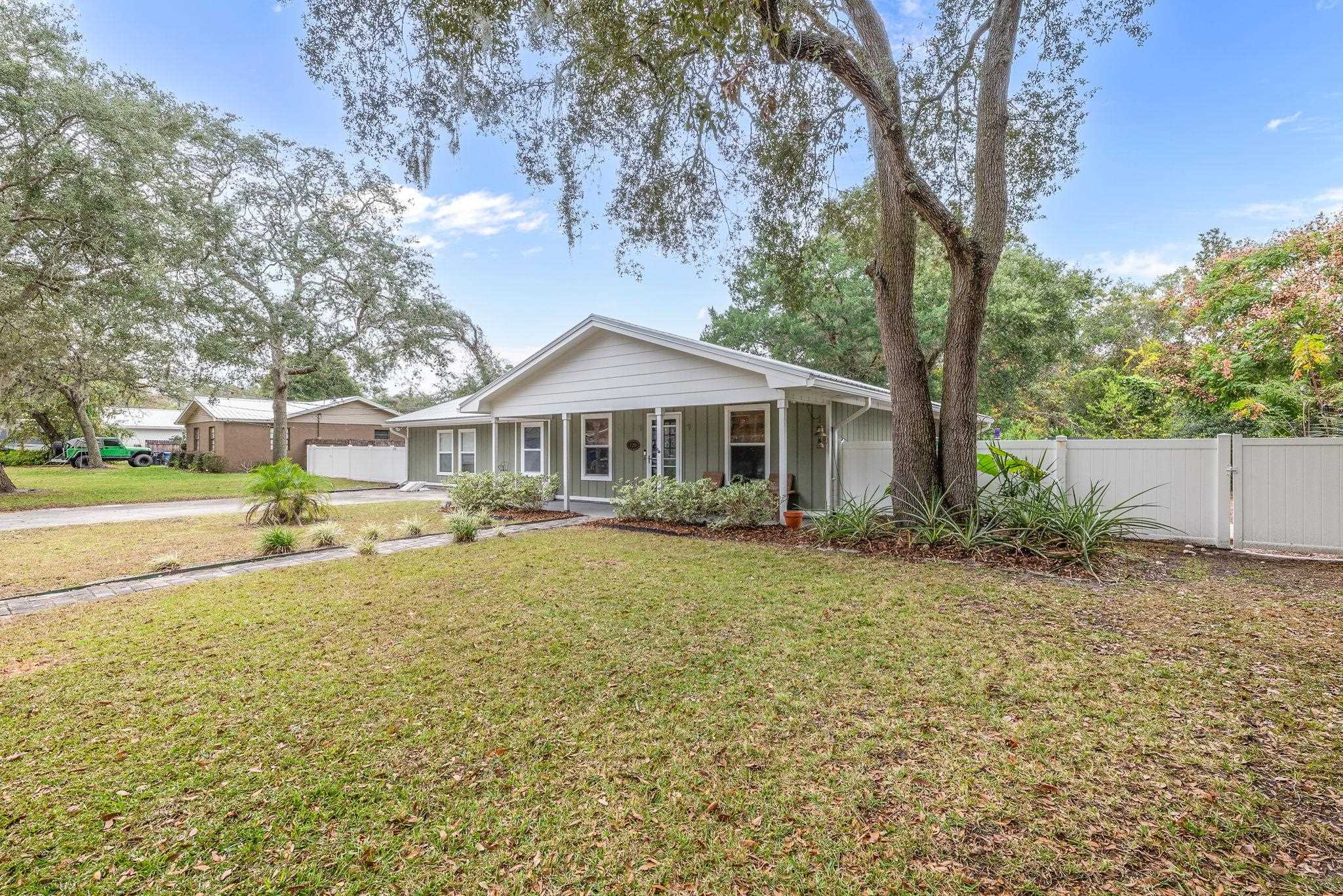 129 Pelican Road St. Augustine, FL 32086 - Photo 11 of 34 View of front of house with covered porch, board and batten siding, a garage, and driveway