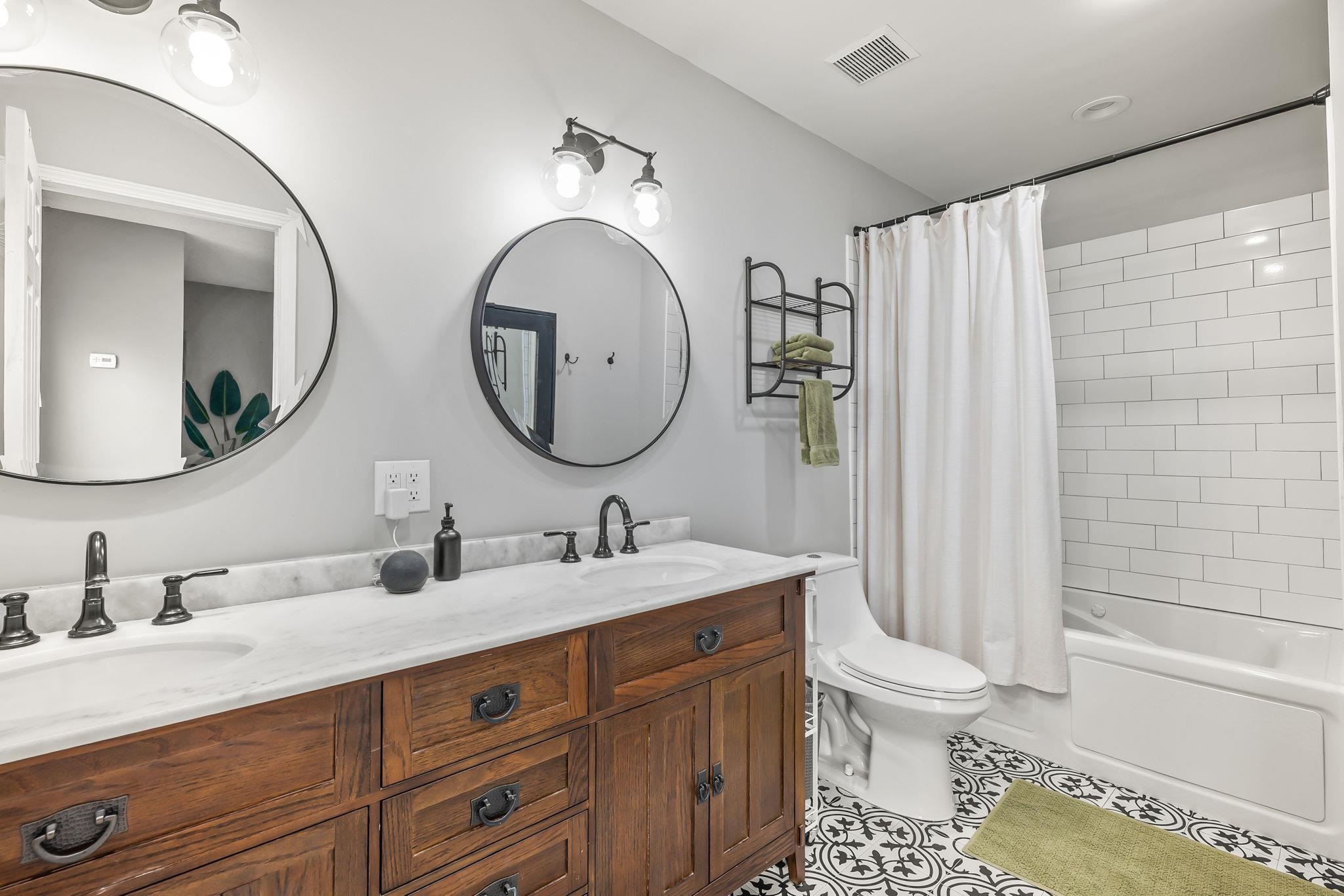 129 Pelican Road St. Augustine, FL 32086 - Photo 2 of 34 Full bathroom featuring shower / bathtub combination with curtain, double vanity, and light tile patterned floors